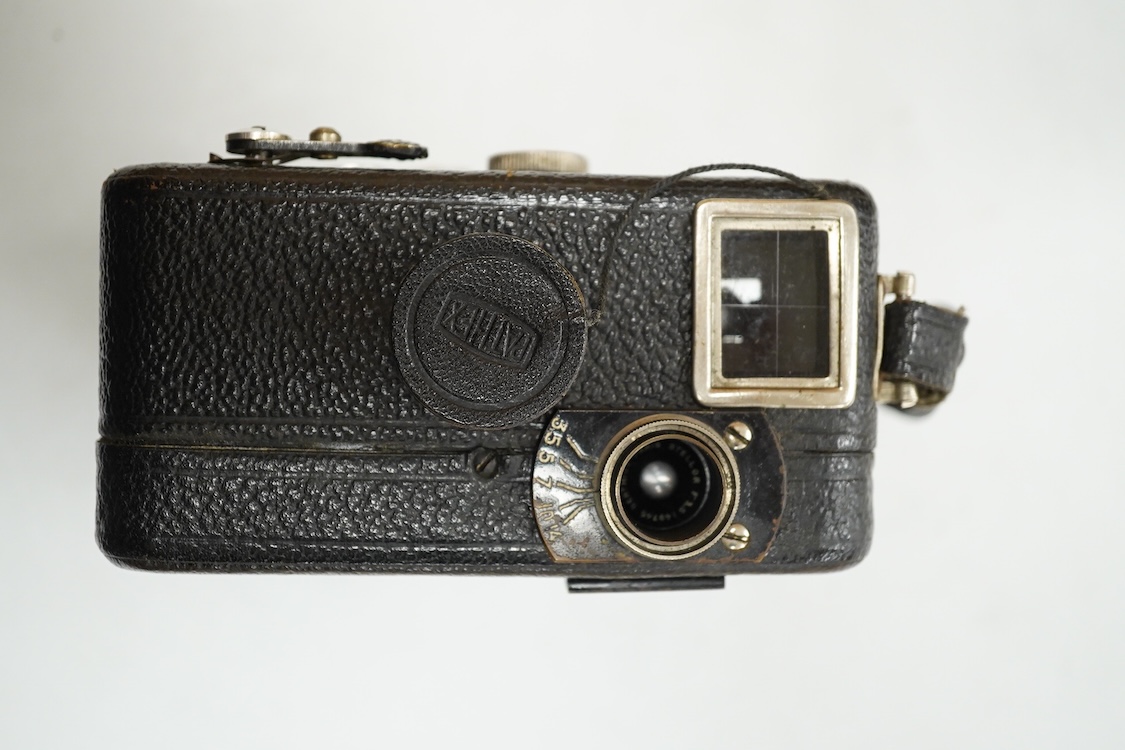 A Pathescope Moto camera 9.5mm cine camera in a brown leather case